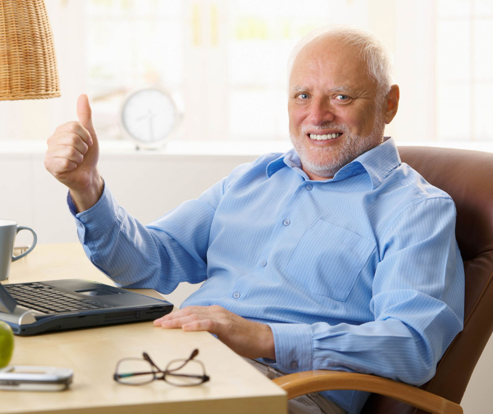 Stock image of man with white hair giving a thumbs up but with a pained expression